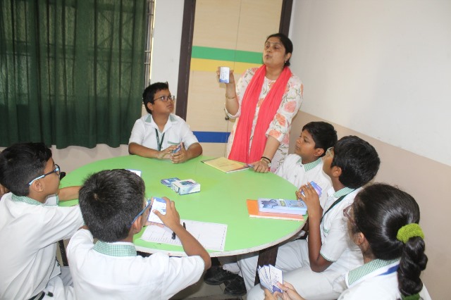 Teacher explaining a concept using flashcards