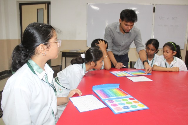 Instructor assisting with colour-coded STEAM tools